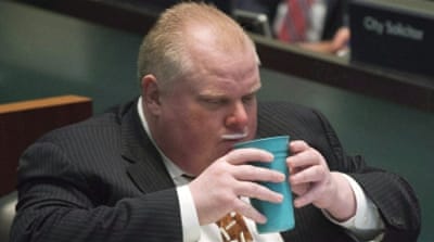 Toronto Mayor Rob Ford displays a milk moustache as he takes part in voting with city council members in Toronto [AP] 