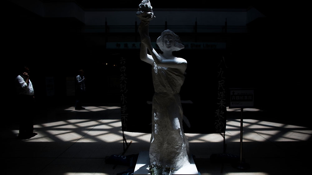 Museum visitors walk past the Goddess of Democracy at the June 4 Memorial Museum [Lam Yik Fei/Getty Images]