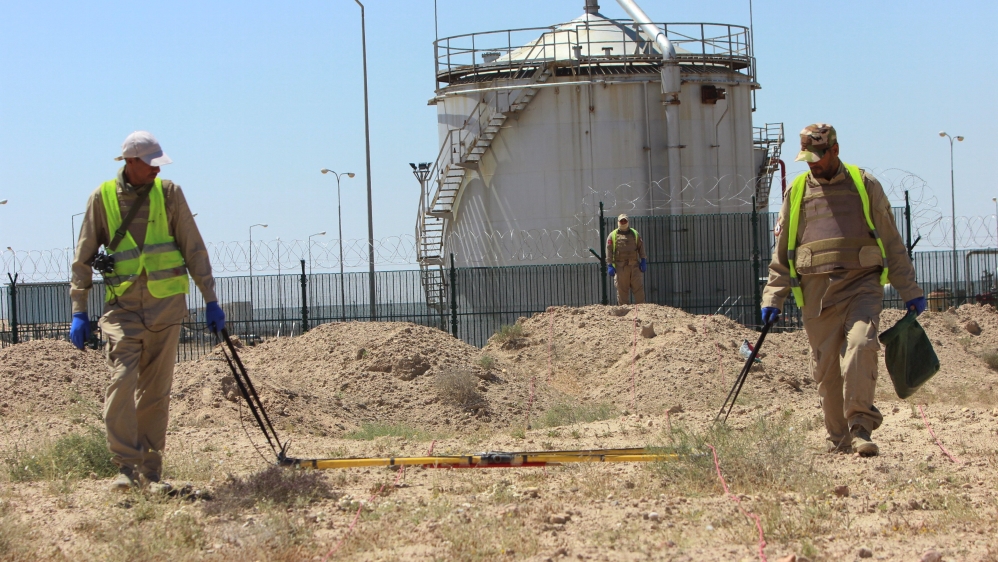 De-mining teams search for landmines in Rumaila oilfield in Basra province, Iraq