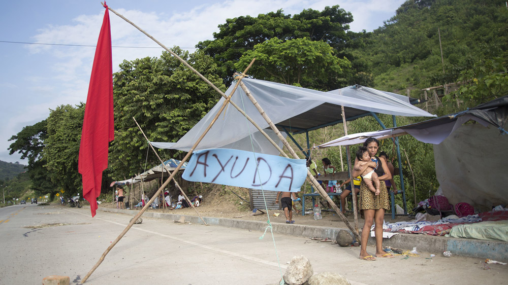 In Pedernales, Ecuador, some residents wait next to the highway to ask people for food and help [Edu Leon/Getty Images]
