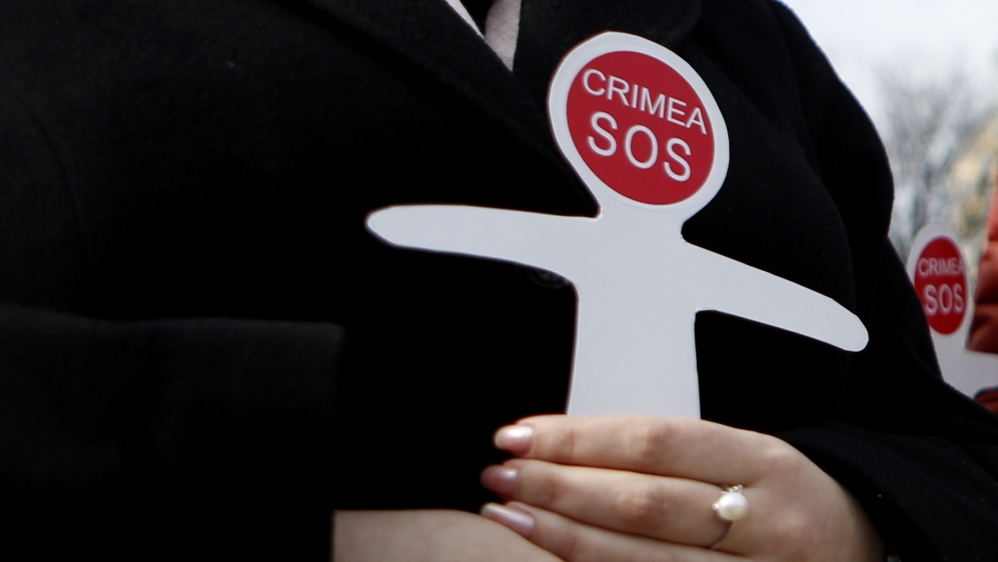 Ukrainian and Crimean Tatar activists hold paper figures symbolizing victims of the Russian annexation of Crimea in Kiev, Ukraine, in 2016. In March 2014, Crimea re-joined Russia following a referendum. More than 82 percent of the electorate took part in the vote. More than 96 percent backed splitting from Ukraine and spoke in favour of reuniting with Russia [File: Sergei Chuzavkov/AP]