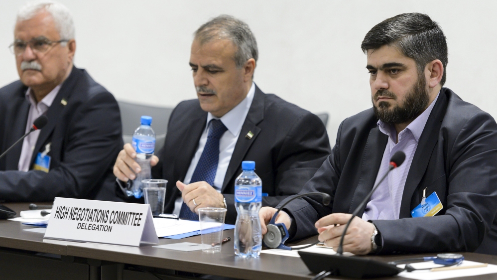 Members of the Syrian opposition delegation of the HNC attend a meeting in Geneva