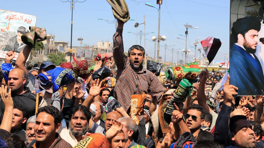 Followers of Iraq''s influential Shia cleric Muqtada al-Sadr chant slogans calling for governmental reforms during a demonstration in Sadr City in Baghdad, Iraq [AP]