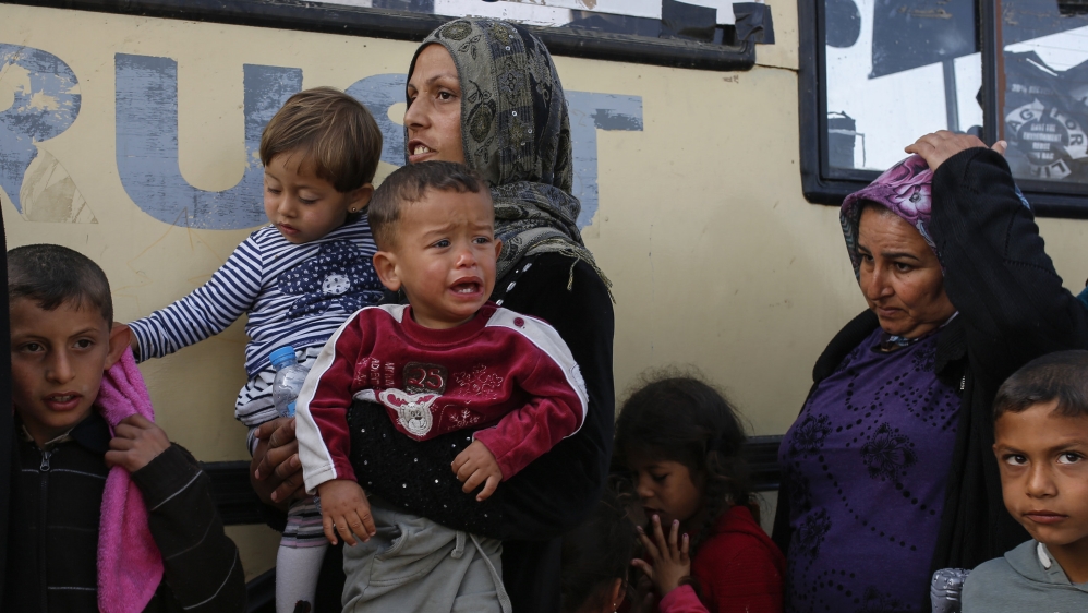 People queue to receive free food at a makeshift camp for migrants and refugees at the Greek-Macedonian border near the village of Idomeni