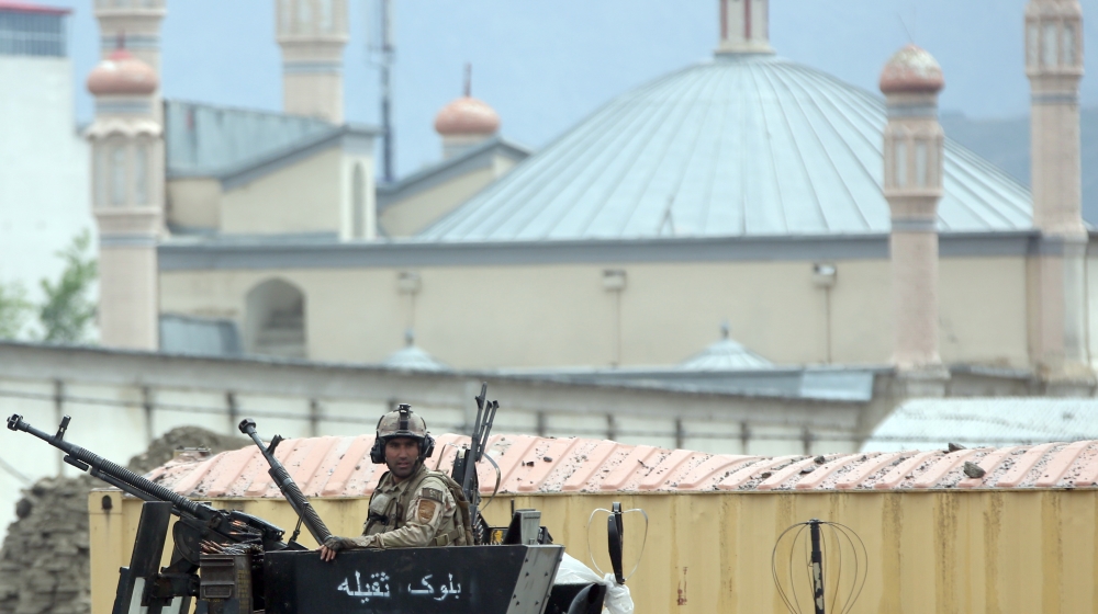 An member of the Afghan security forces stands guard at the site of a Taliban-claimed suicide attack in Kabul, Afghanistan [AP]