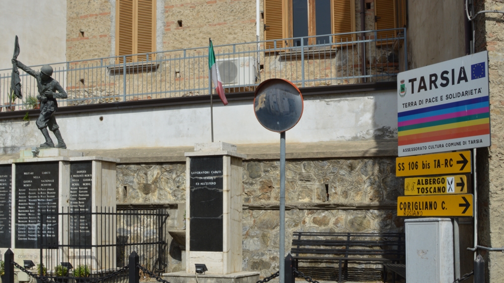 Sign in Tarsia that reads: 'A land of peace and solidarity' [Rosie Scammell/Al Jazeera] 
