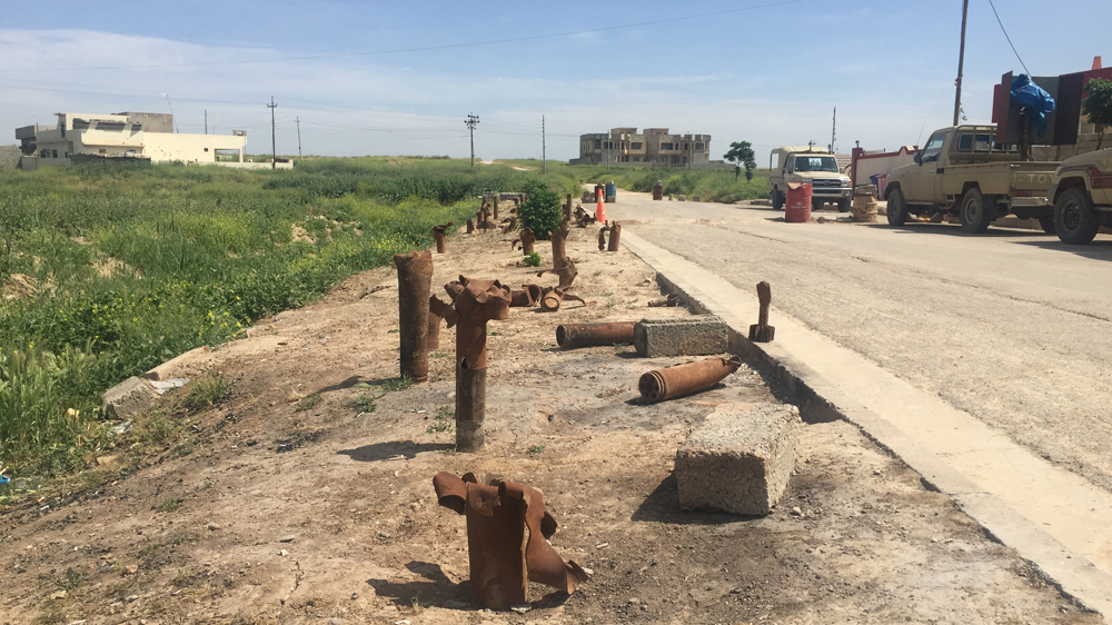Mortars fired by ISIL at the Peshmerga and Dwekh Nawsha litter the ground in Baqofah, Iraq [Adam Lucente/Al Jazeera]