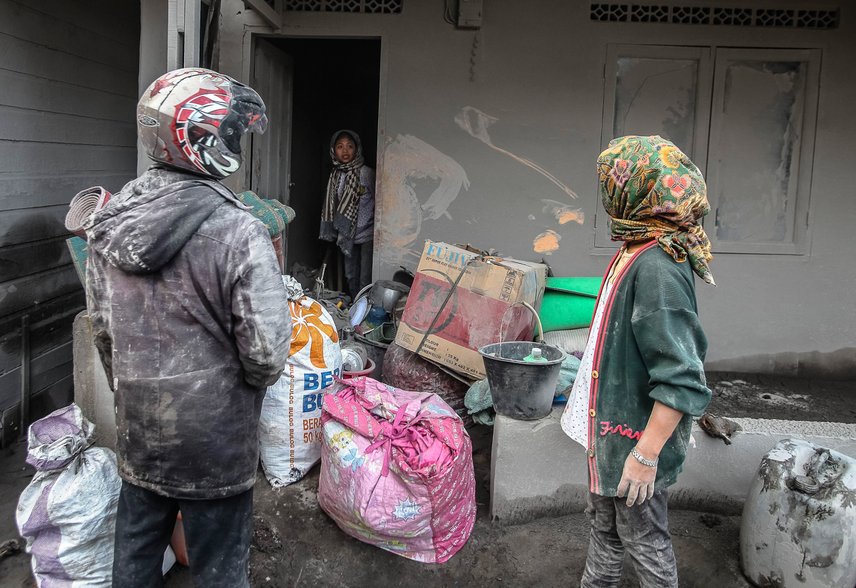 Mount Sinabung Eruption Aftermath Residents collect their belongings as they evacuate from a village impacted by the Mount Sinabung eruption at Gamber Village,