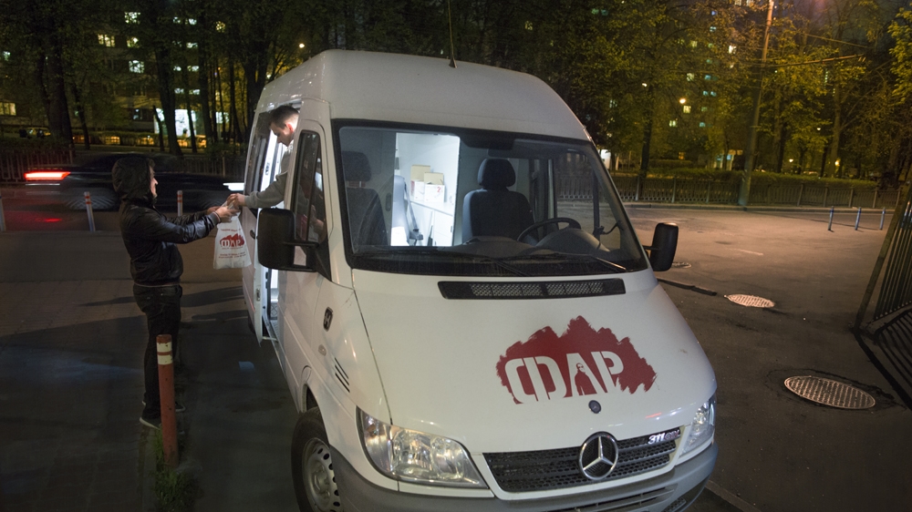  An outreach worker with the Andrey Rylkov Foundation in Moscow distributes a bag with materials that could include clean syringes, ointments and information [Andrey Rylkov Foundation] 