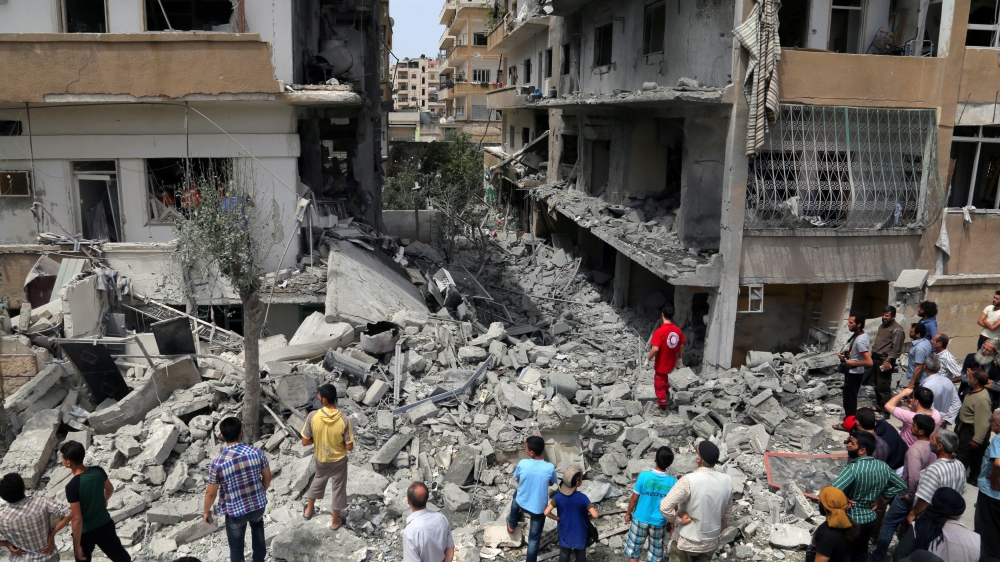 Rescuers and civilians inspect a site hit by an airstrike in Idlib, Syria [REUTERS]