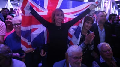 A Brexit supporter holds a Union Flag at a Vote Leave rally in London