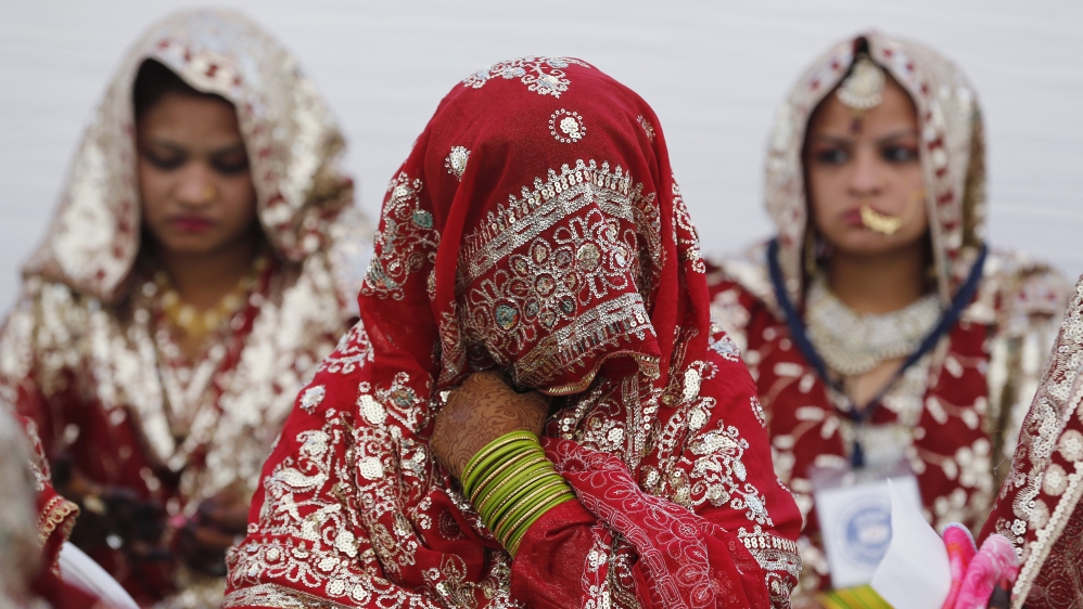 Muslim brides wait for the start of a mass marriage ceremony in Ahmedabad