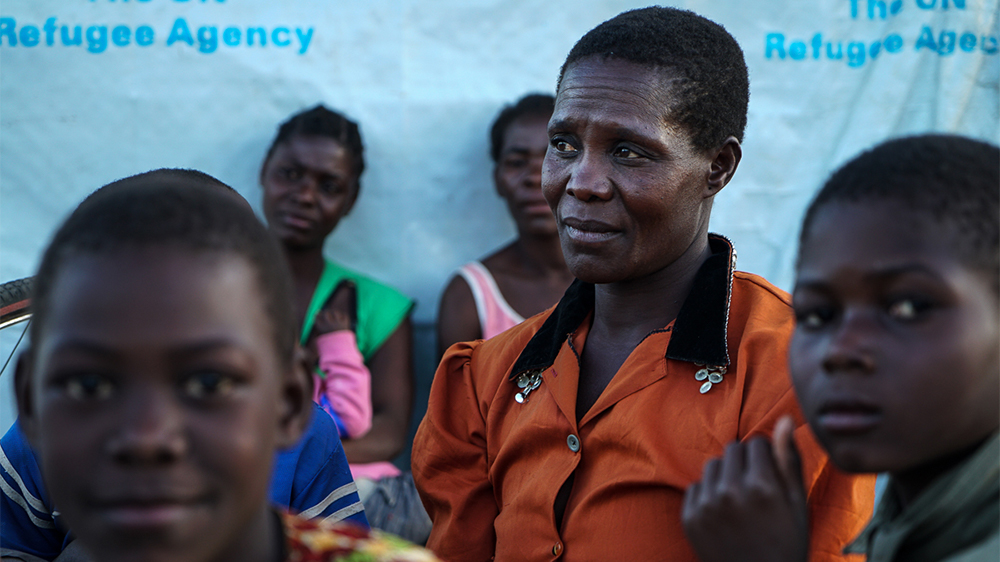  Margaret (in orange) says her children are happier now they are at the camp, and it gives her renewed hope for their futures [Sorin Furcoi/Al Jazeera]