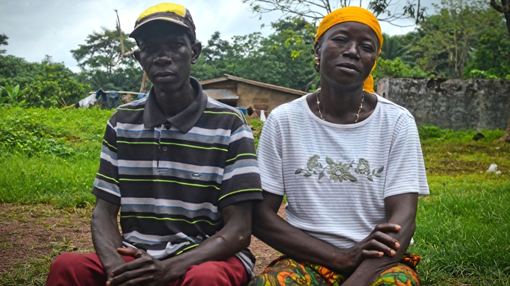 David's aunt Sia and teacher Andrew have been helping him deal with his disability [Cooper Inveen/Al Jazeera]