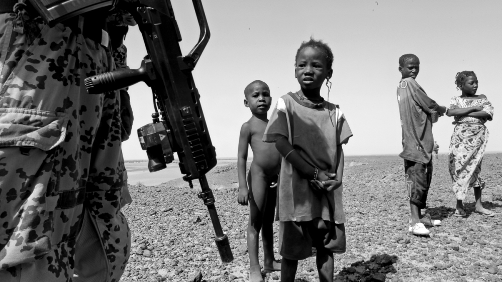 
The peacekeepers talk to children during the patrol [ Marielle van Uitert/Al Jazeera] 