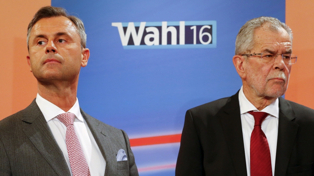 Presidential candidates Van der Bellen and Hofer react during a TV debate in Vienna