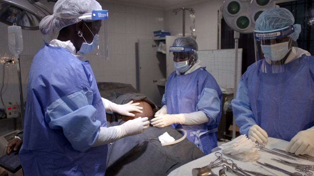 Gibson, left, learned how to perform surgical procedures for simple pregnancy complications during the Ebola crisis [Dan Boaden/Al Jazeera]