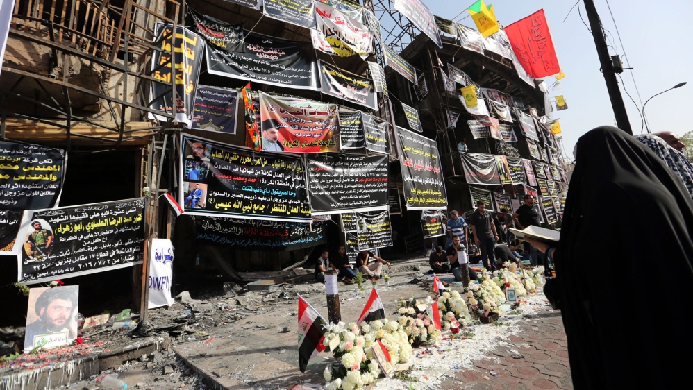 Iraqis take part in a prayer vigil at the site of the suicide truck bomb attack in Karada [File: EPA]
