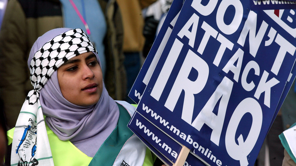 A protester holds a banner at London's anti-war demonstration in February 2003 [Stephen Hird/Reuters]