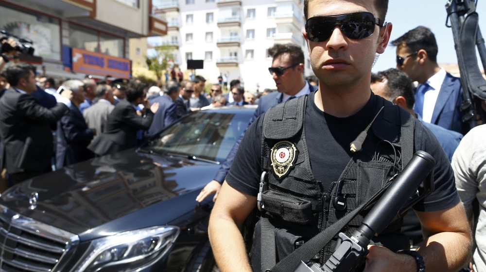 Security guard the car of Turkish PM Yildirim before a funeral service for a victim of the thwarted coup in Ankara