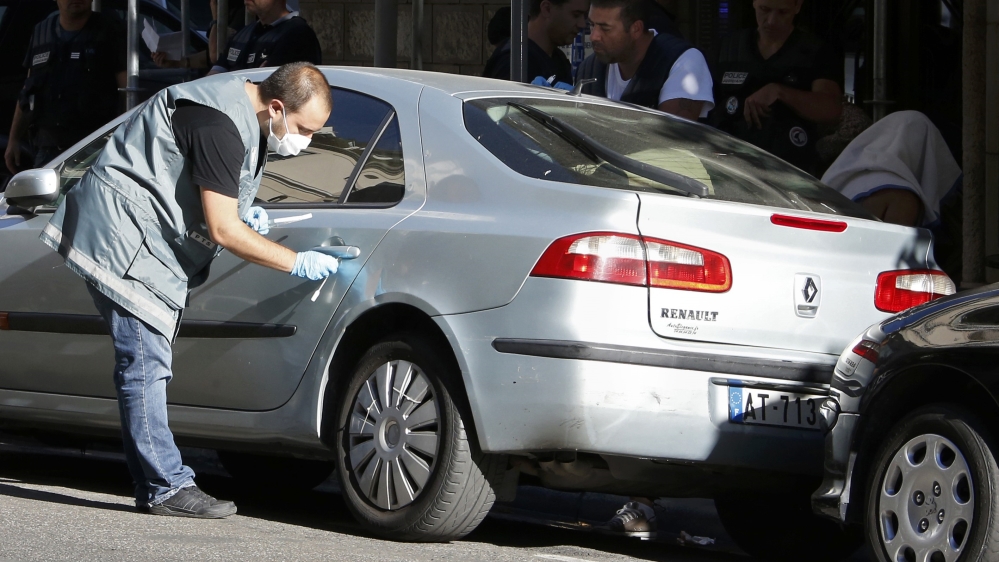 A man covered with a towel is apprehended by French police as the investigation continues two days after an attack by the driver of a heavy truck who ran into a crowd killing scores and injuring as m