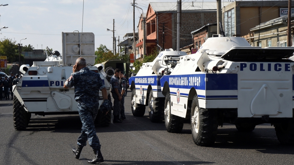 Policemen block a street after group of armed men seized a police station along with an unknown number of hostages, according the country''s security service, in Yerevan, Armenia