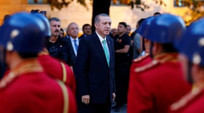 Turkish President Tayyip Erdogan reviews a guard of honour as he arrives to the Turkish Parliament in Ankara