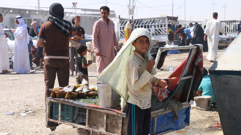 After his father died in a bombing attack, eight-year-old Abdul Karim had to find a job [Al Jazeera]