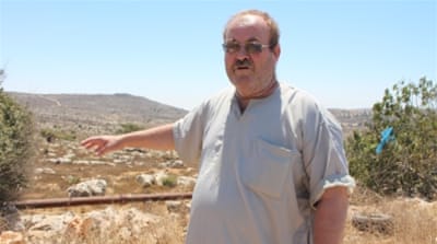 Atallah Abdelhafez can see part of his family's land on the forested ridge where the Amona outpost was built [Nigel Wilson/Al Jazeera]
