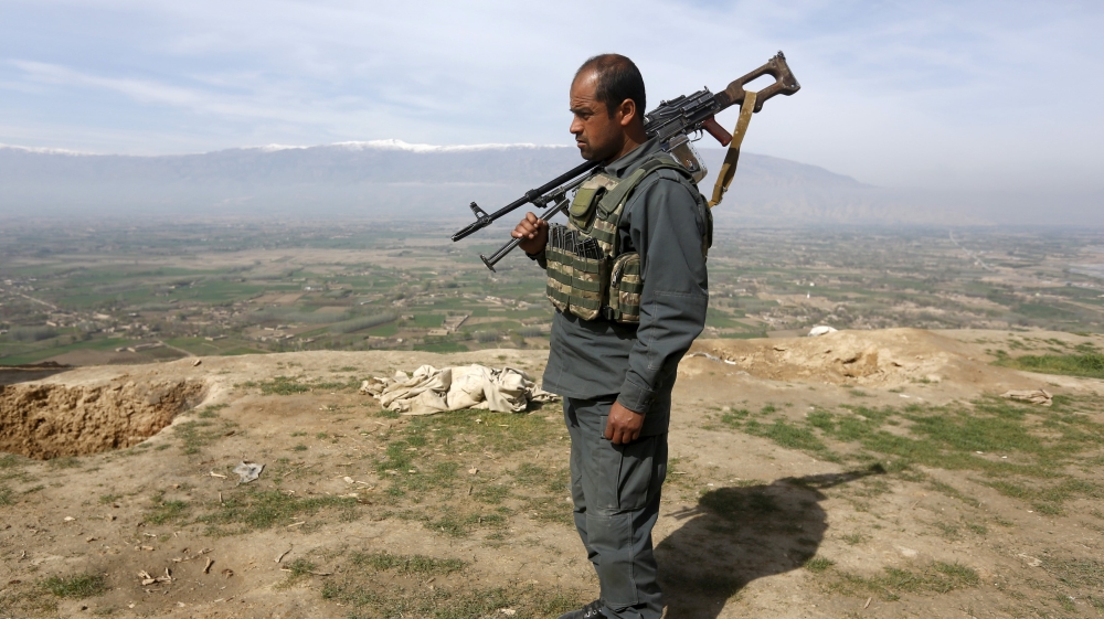Afghan policeman keeps watch at a hilltop in Dand Ghori district of Baghlan