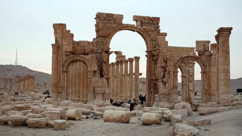 Tourists walk in the historical city of Palmyra, April 14, 2007. ISIL destroyed this arch after taking control of the city [Nour Fourat/Reuters]