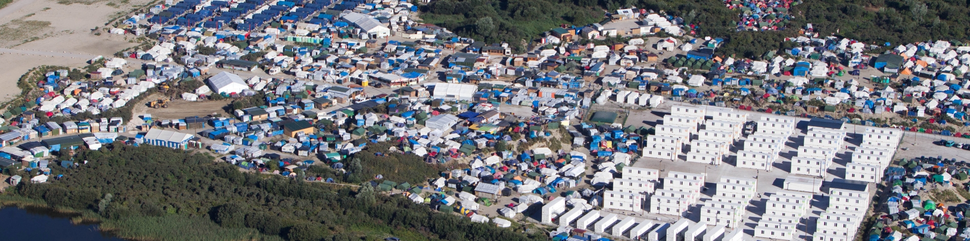 File: An aerial view of the migrant camp in Calais [Michel Spingler/AP]
