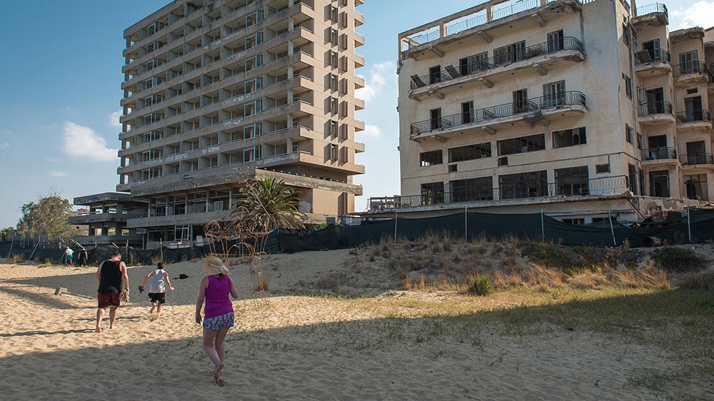 The empty buildings in Varosha have become just another feature of the landscape for Famagusta beachgoers [Wojtek Arciszewski/Al Jazeera]