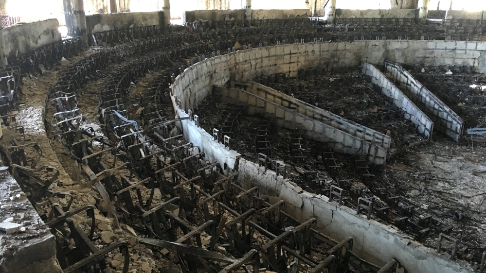 The charred interior of the parliament is seen after it was burned in post-election protests in Libreville [Edward McAllister/Reuters]