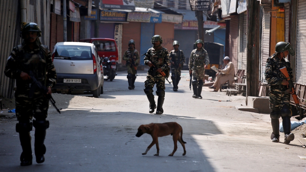 Indian policemen patrol a street during a strike called by Kashmiri separatists in Srinagar, against the recent killings in Kashmir region