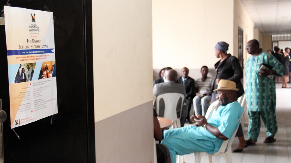 Participants wait in the hallway of the courthouse until their case is called [Femke van Zeijl/Al Jazeera]