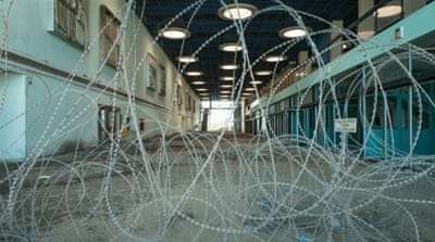 Old advertisements can be seen on the walls of the deserted airport terminal [Wojtek Arciszewski/Al Jazeera]