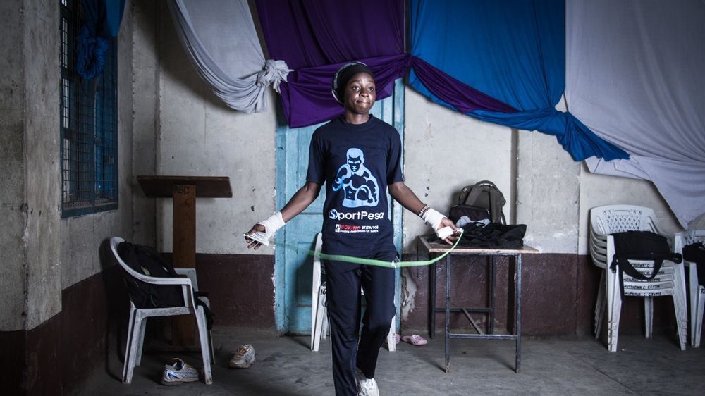 Veronica Mbithe, 20, warming up inside the Muthurwa gym that houses the Dallas Boys club [Humphrey Odero/Al Jazeera] 