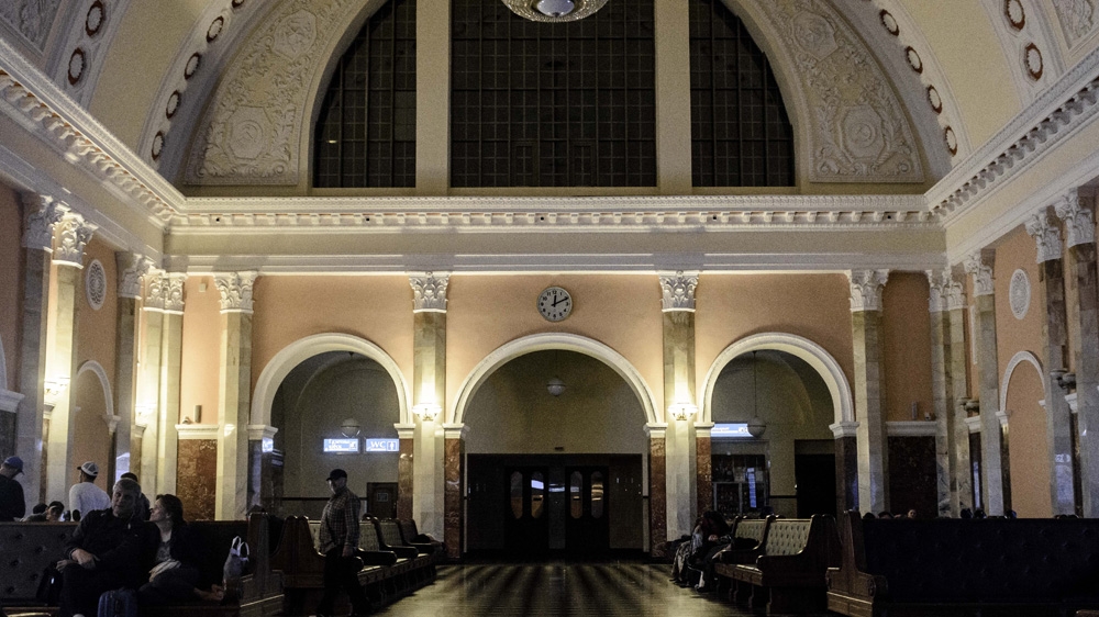 Many families sleep at the train station. Having sold all their possessions, they usually arrive with a few thousand euros. 'The money is finished, completely,' said one man, 'but there’s no way back' [Ben Gerdziunas/Al Jazeera] 