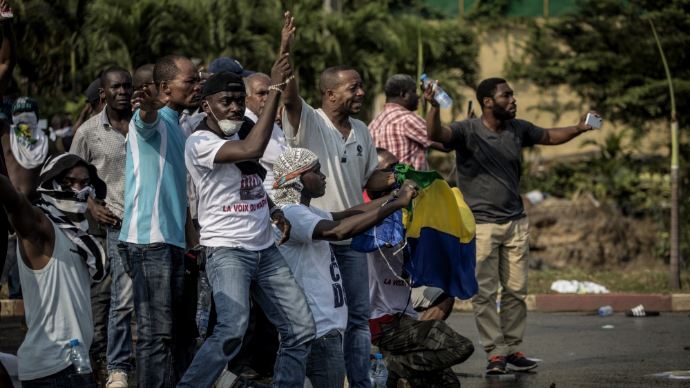 Supporters of Gabonese opposition leader Jean Ping face security forces blocking the demonstration trying to reach the electoral commission [AFP]