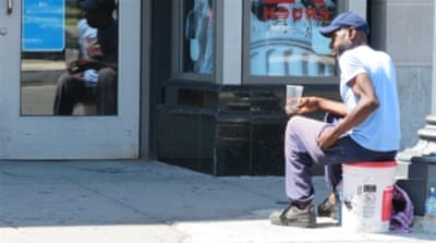 Tony Leonard asks passers-by for change outside of a DC pharmacy. He will be voting for Clinton this November. 'She's the most qualified candidate I've ever seen,' he says [Jessica Sarhan/Al Jazeera] 