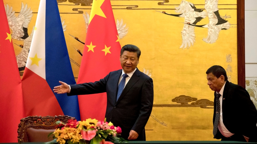 Philippine President Rodrigo Duterte is shown the way by Chinese President Xi Jinping before a signing ceremony held in Beijing