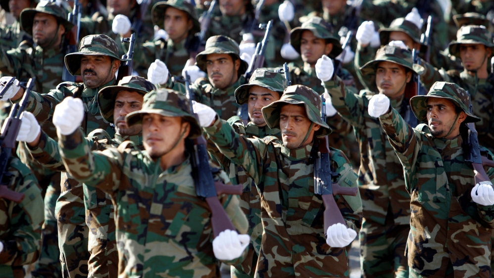 ShiÕite paramilitary groups known as Hashid Shaabi (Popular Mobilisation) take part in a military parade at Tahrir Square in central Baghdad, Iraq