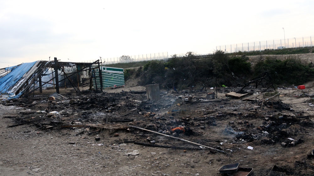The charred remains of the Kids' Cafe, once a large shelter in the Jungle. It was a refuge where young people could come to learn skills, play games and get support [Caelainn Hogan/Al Jazeera]
