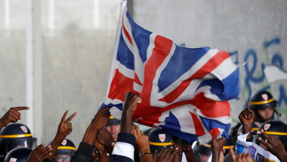 French police face off with demonstrators who are holding a march near the area called the "Jungle", where migrants live, in Calais