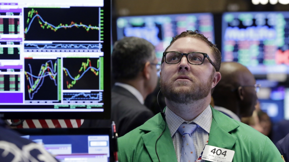 Trader Ryan Falvey works on the floor of the New York Stock Exchange [AP Photo/Richard Drew]