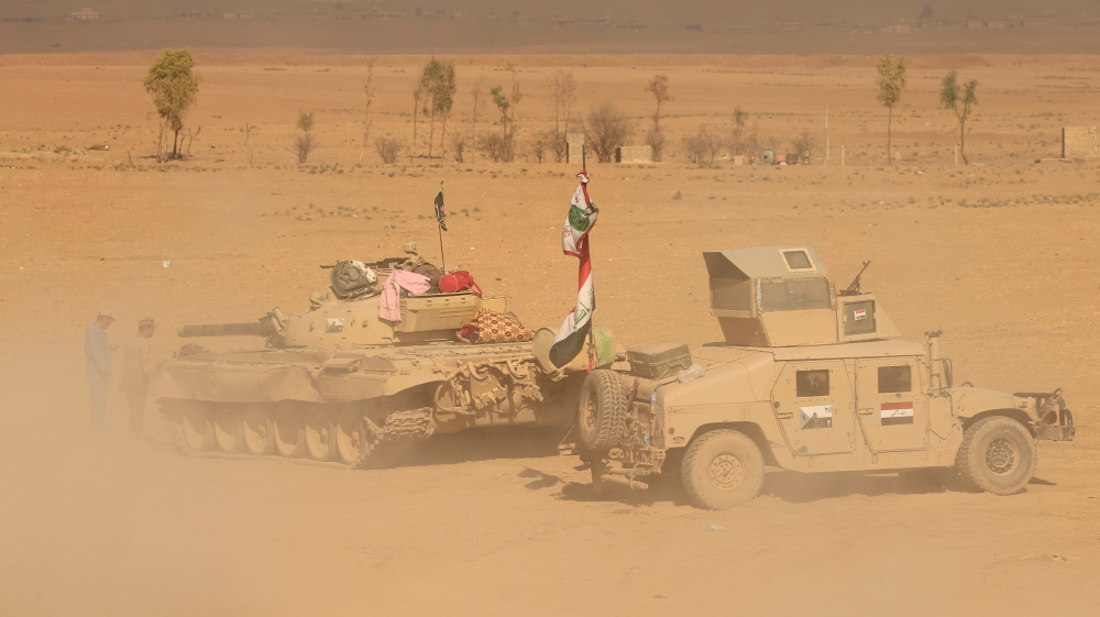 Iraqi security forces are seen during a battle with Islamic State militants in Ali Rash