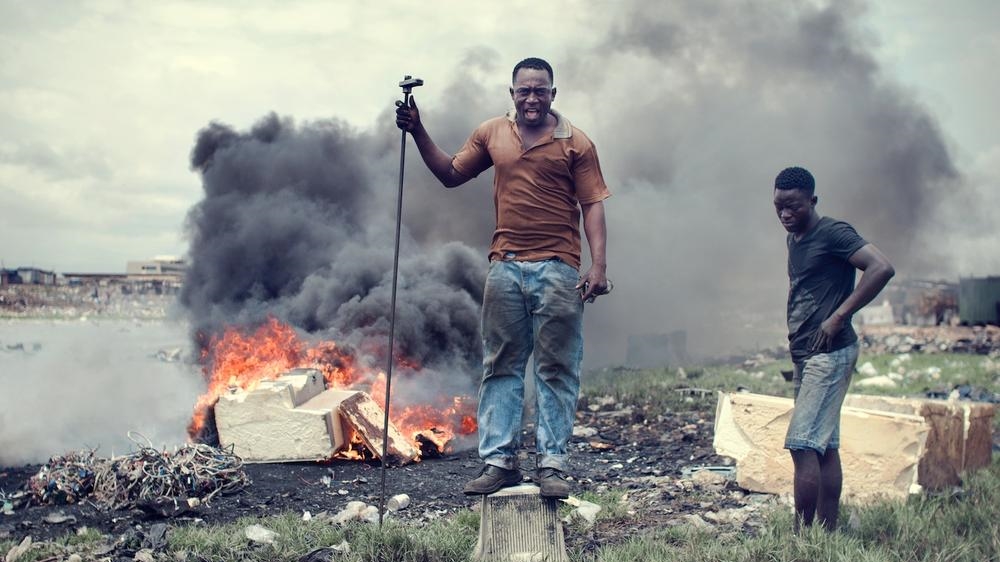 Agbogbloshie is the world's biggest e-waste dumpsite and is located near Accra, Ghana. Electronic waste - TVs, PCs, hi-fi systems, refrigerators - defines the landscape of this former wetland and recreation area. Here in Agbogbloshie, boys and men aged between seven and 25 smash stones and simple tools against TVs and PCs to get to the metals, particularly the copper. They will earn about $2.50 for a day's work. Most of them left families in the impoverished northern and upper west regions of Ghana when they came to work here. [Kevin McElvaney/Al Jazeera]