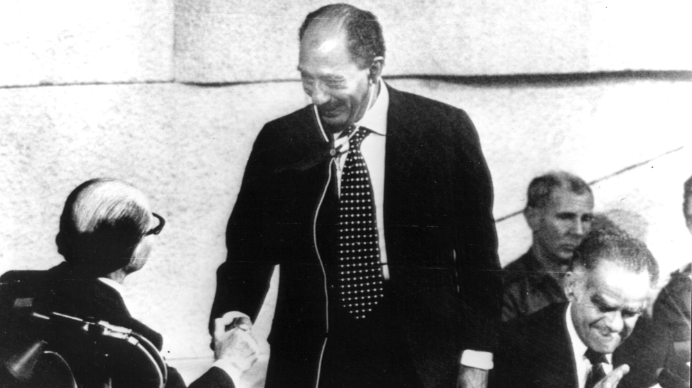  Egyptian President Anwar al-Sadat shakes hands with former Israeli PM Menachem Begin after addressing the Israeli government on November 20, 1977 [The Associated Press]
