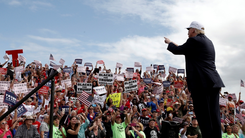 Republican U.S. presidential nominee Donald Trump greets cheering supporters as he arrives at a campaign rally in Lakeland